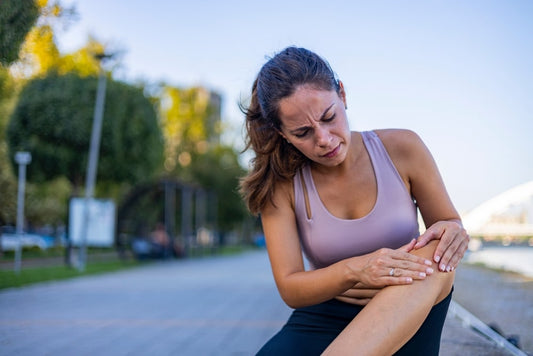 woman in park running has knee pain