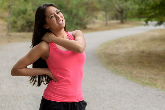 woman out jogging suffers a shoulder muscle injury