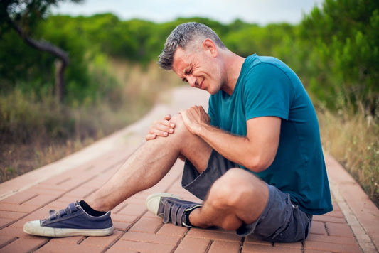 man with agonizing knee pain