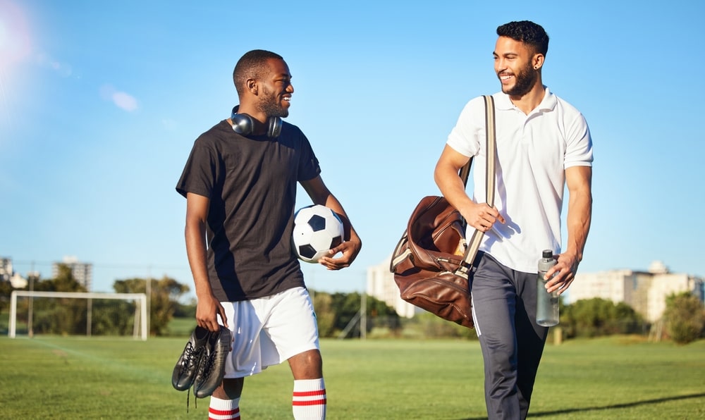 soccer players walking on field after practice