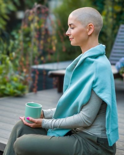 woman cancer patient sitting on a porch